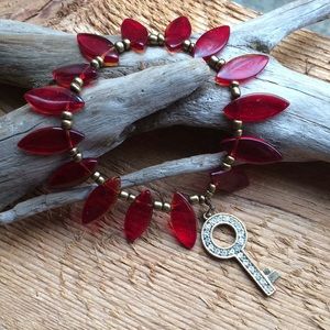 Handmade glass bead bracelet with key charm